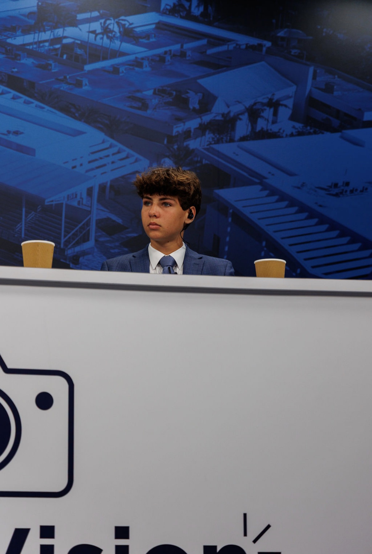 Ari, the student behind HBF, seated at a studio broadcast desk